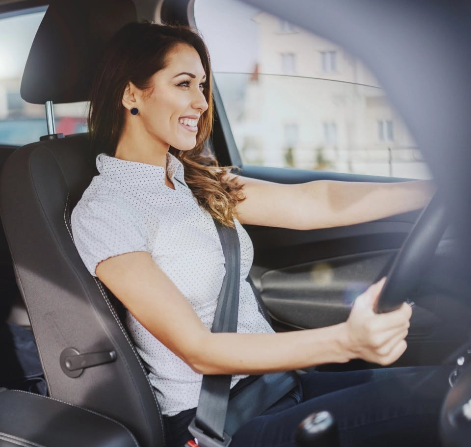 Woman smiling in her car